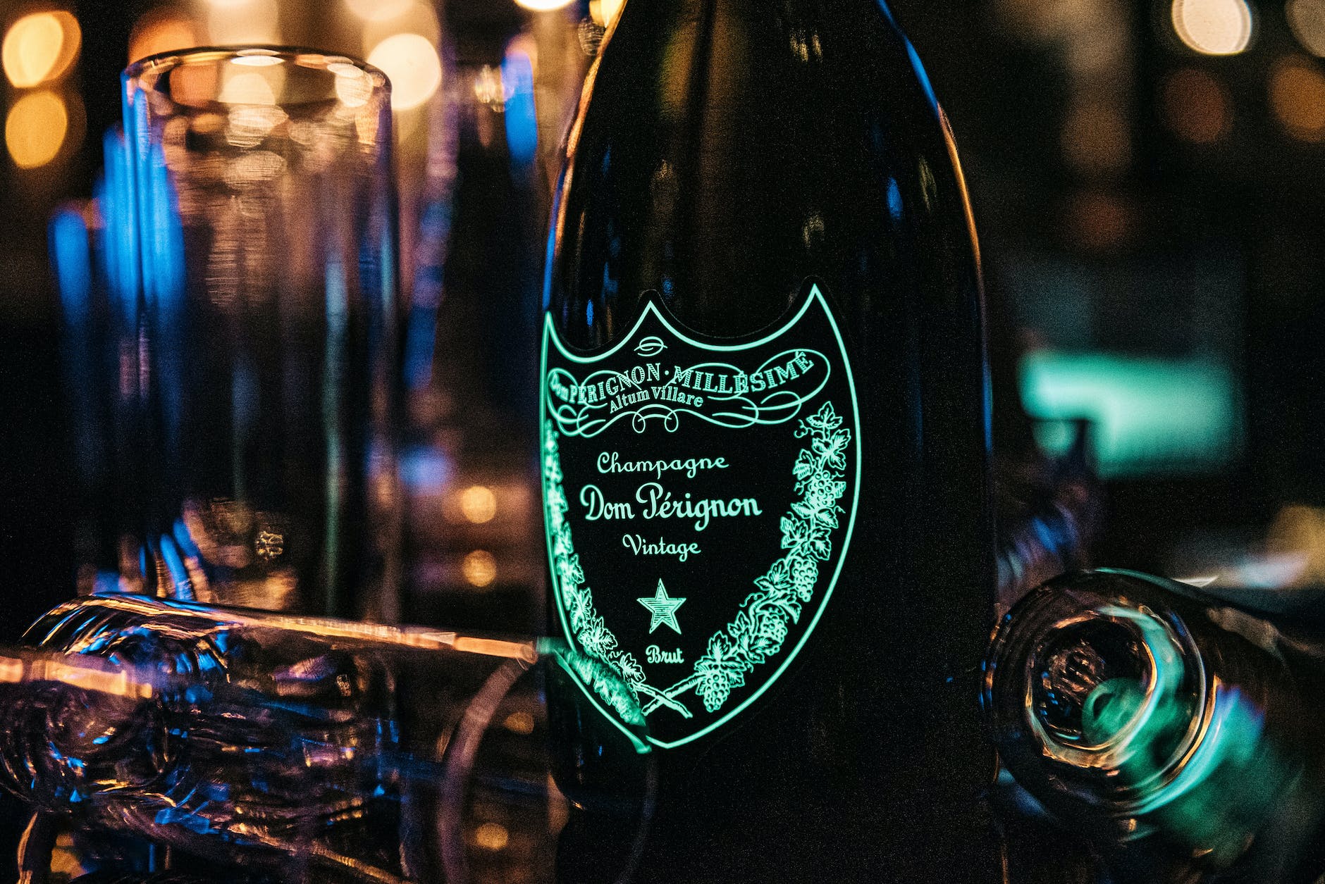 a bottle of champagne and clear glasses